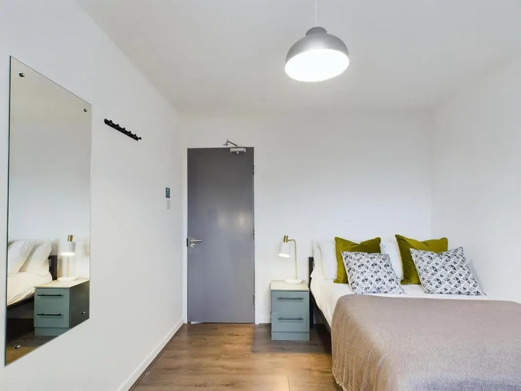 Bed nightstand lamp mirror door bedroom at 6 Bedroom House at 2, Flat 2, Windsor House, Clint Road West in Liverpool Student Accommodation