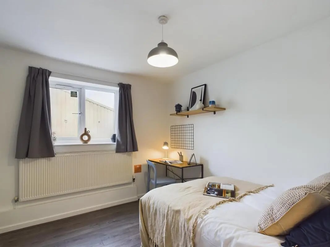 Bed desk lamp shelf and window Bedroom at 6 Bedroom House at 2, Flat 2, Windsor House, Clint Road West in Liverpool Student Accommodation