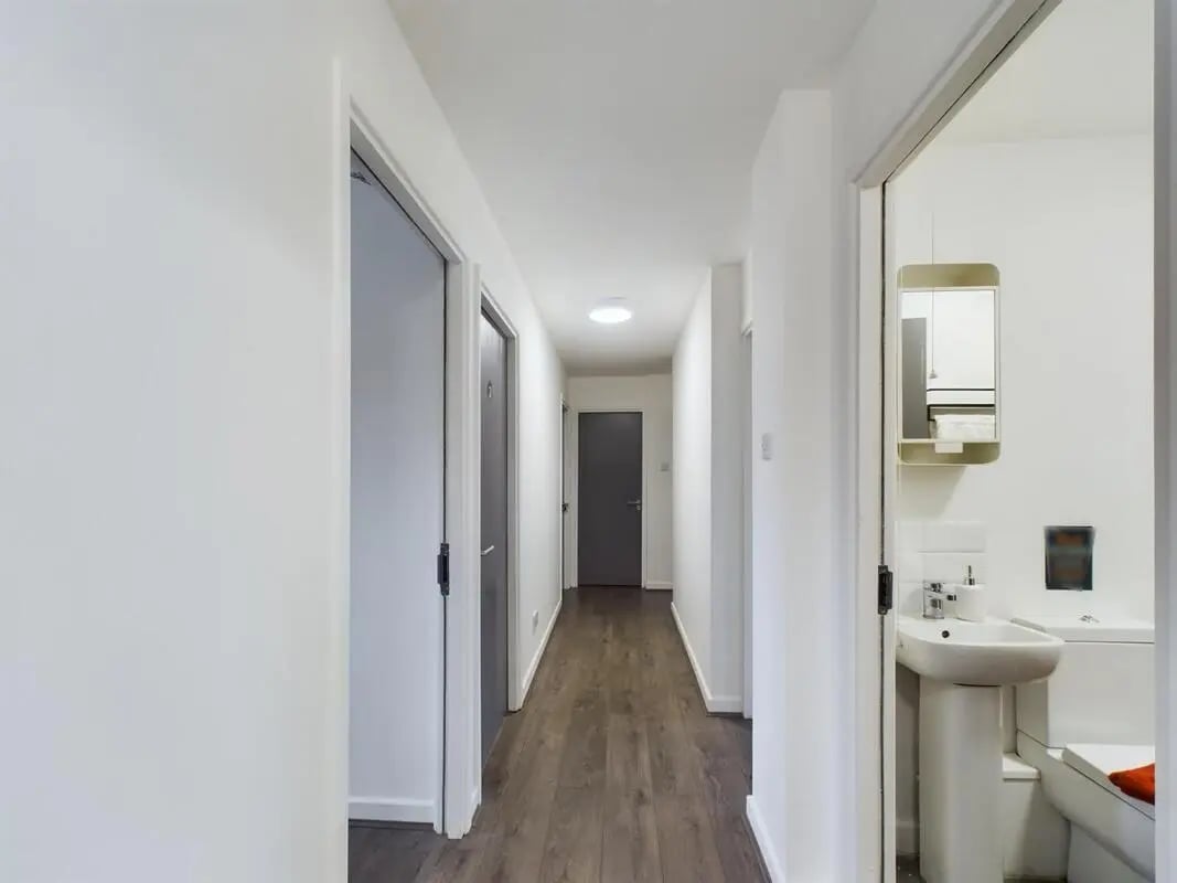 Hallway with doors and visible sink and toilet Bathroom at 6 Bedroom House at 2, Flat 2, Windsor House, Clint Road West in Liverpool Student Accommodation
