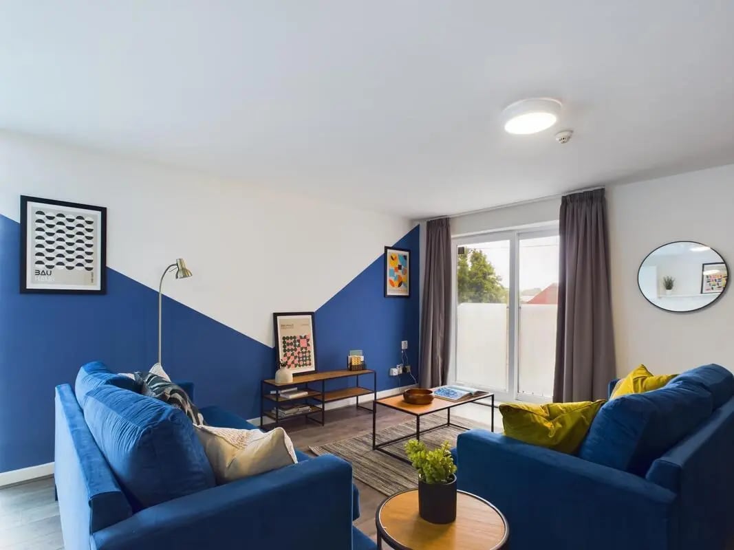 Two blue sofas coffee table living room at 6 Bedroom House at 2, Flat 2, Windsor House, Clint Road West in Liverpool Student Accommodation