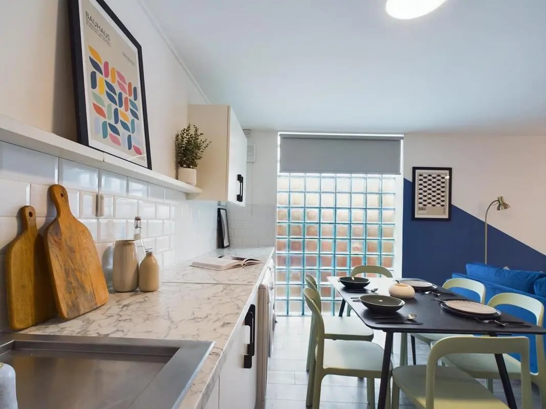 Marble countertops cutting boards plant and poster kitchen at 6 Bedroom House at 2, Flat 2, Windsor House, Clint Road West in Liverpool Student Accommodation