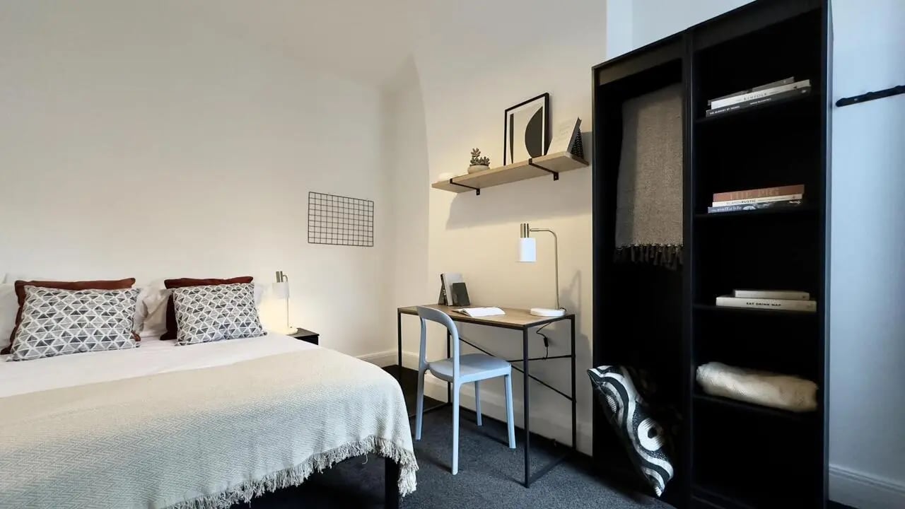 Bed desk bookshelf and pillows bedroom at 4 Bedroom House at 126, Empress Road in Liverpool Student Accommodation
