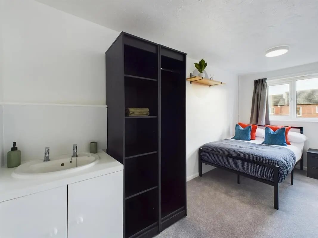 Sink black wardrobe bed with pillows bedroom at 6 Bedroom House at 9, Sage Road in Leicester Student Accommodation