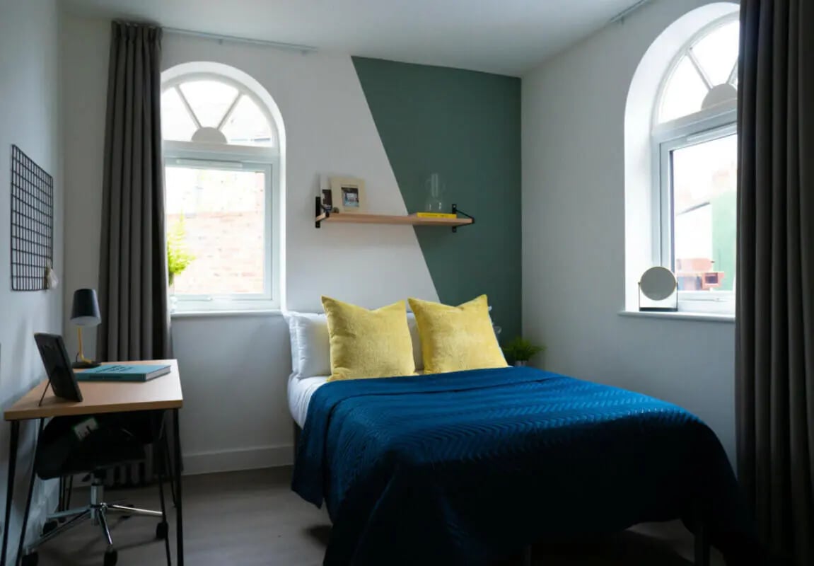 Bed desk and arched windows bedroom at 8 Bedroom House at 79, Crofton Street in Manchester Student Accommodation