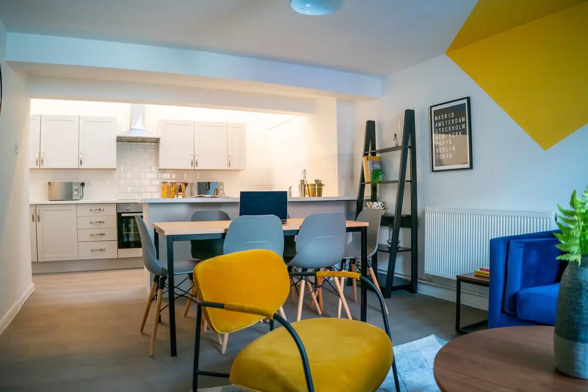 Kitchen dining area with yellow chairs and blue sofa Living Area at 6 Bedroom House at 64A, Monson Street in Lincoln Student Accommodation