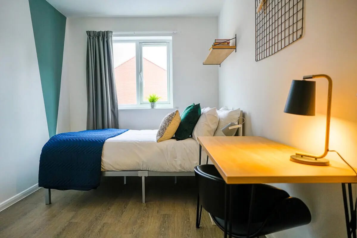Bed desk lamp and pillows bedroom at 6 Bedroom House at 64A, Monson Street in Lincoln Student Accommodation