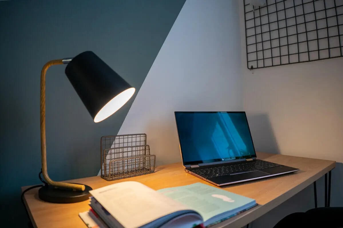 Desk with lamp laptop books wire organizer study area at 6 Bedroom House at 64A, Monson Street in Lincoln Student Accommodation