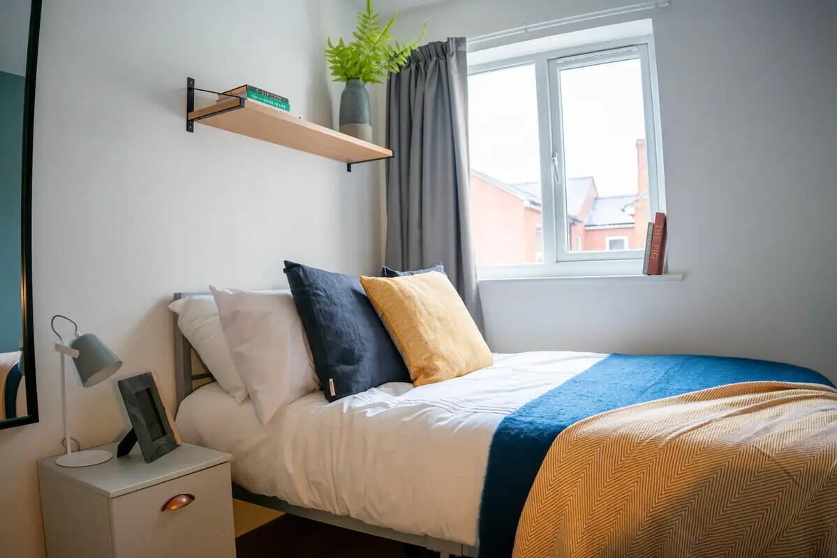 Bed pillows blankets window bedside table bedroom at 6 Bedroom House at 64A, Monson Street in Lincoln Student Accommodation