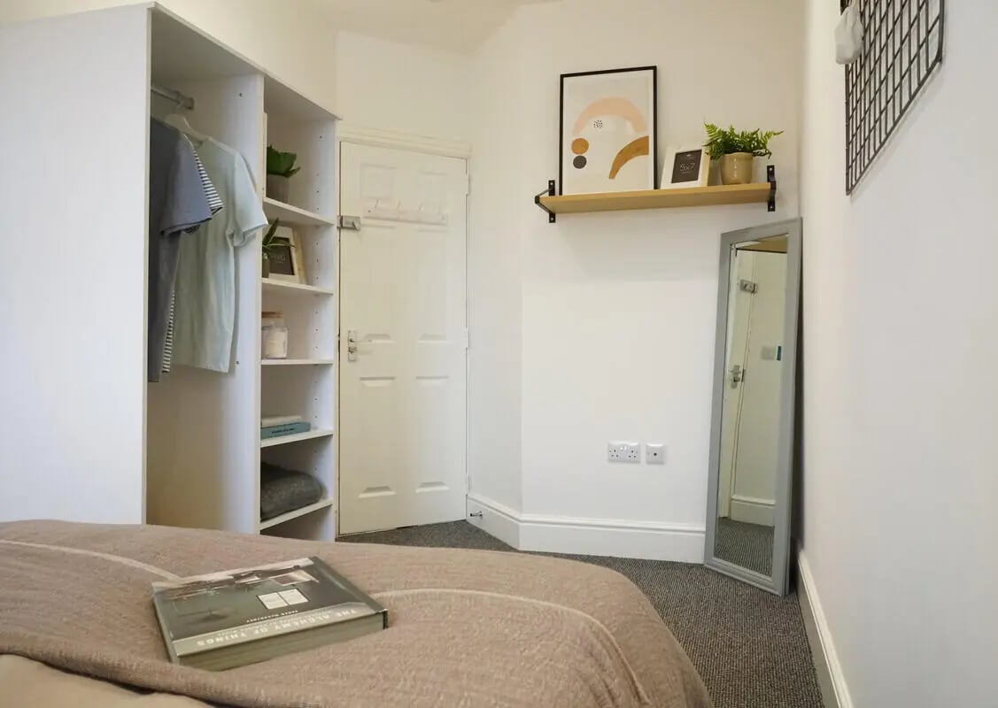 Closet shelves mirror art on wall bedroom at 6 Bedroom House at 1, Baggholme Road in Lincoln Student Accommodation