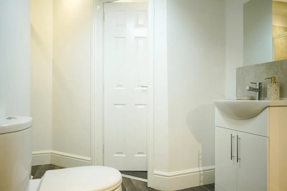Toilet sink and door in clean bathroom at 6 Bedroom House at 1, Baggholme Road in Lincoln Student Accommodation