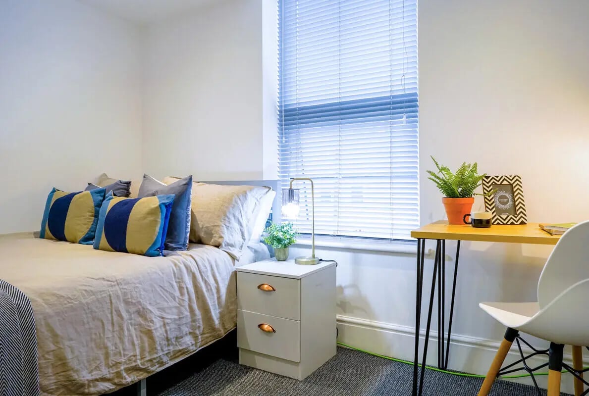 Bed pillows desk lamp framed photo bedside table Bedroom at 6 Bedroom House at 1, Baggholme Road in Lincoln Student Accommodation