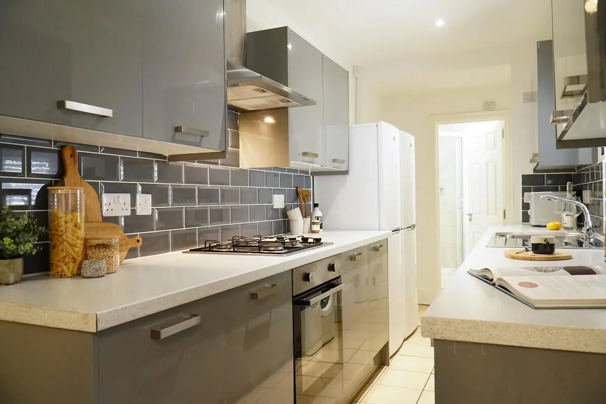 Modern grey cabinets stovetop and refrigerators kitchen at 6 Bedroom House at 3, Baggholme Road in Lincoln Student Accommodation