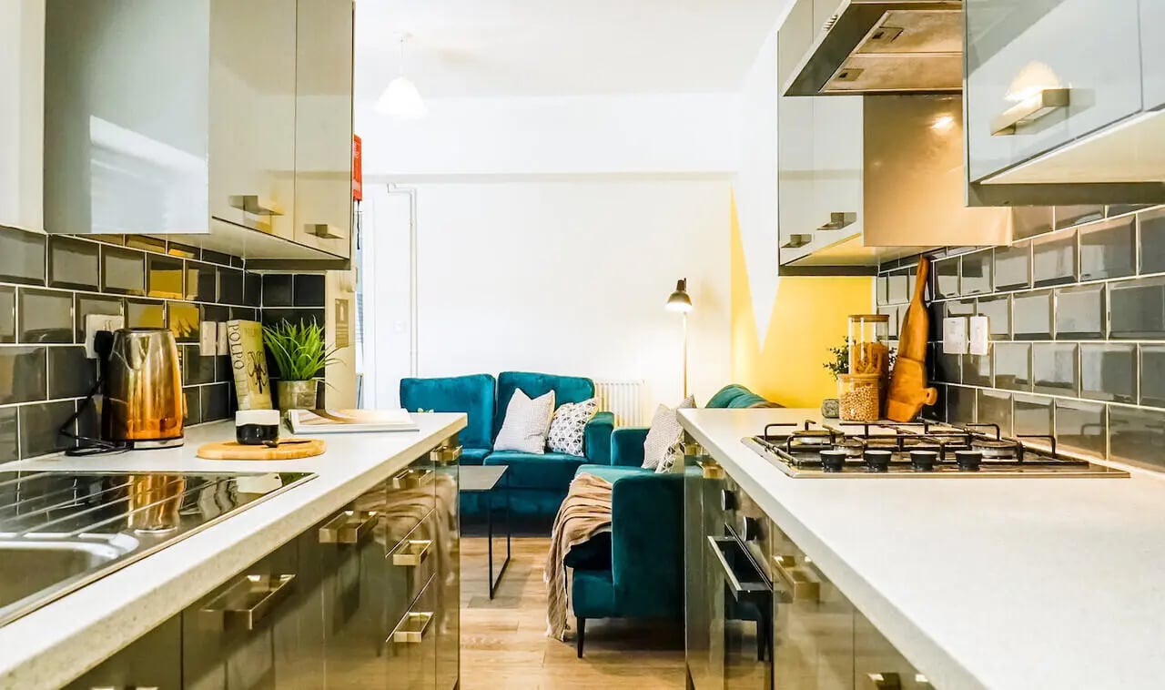 Modern kitchen with teal sofas and living area kitchen at 6 Bedroom House at 3, Baggholme Road in Lincoln Student Accommodation