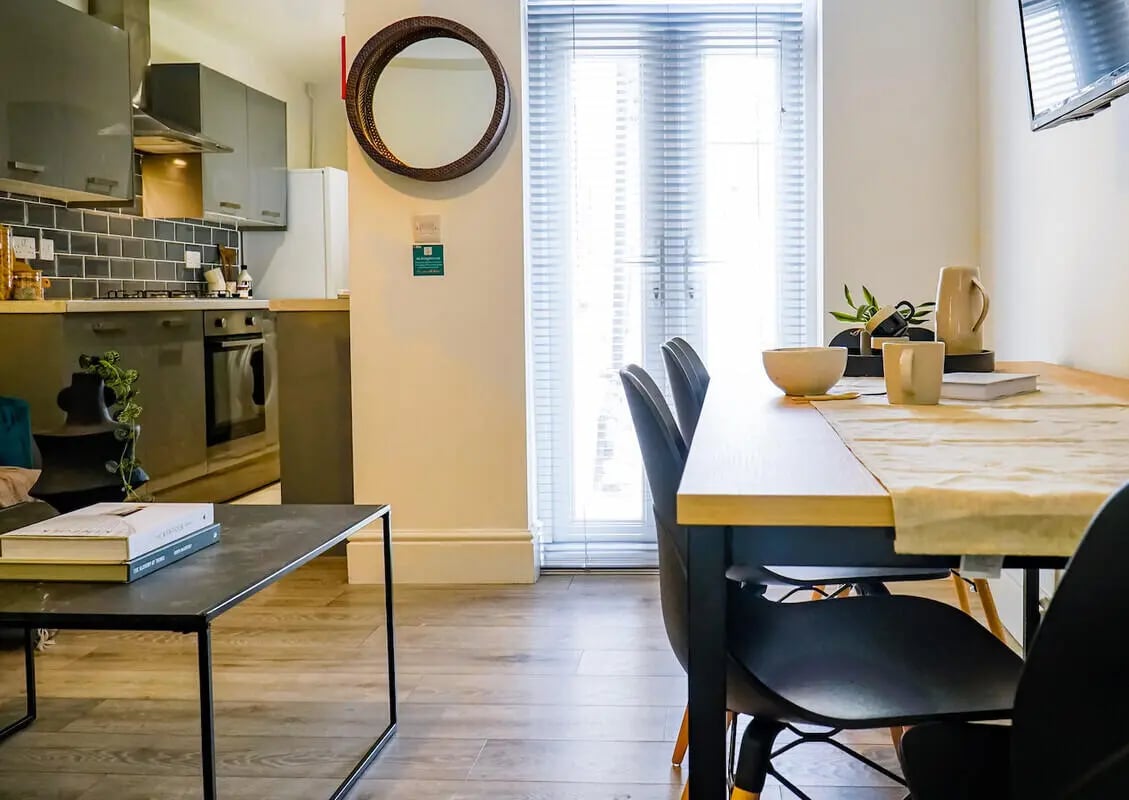 Kitchen dining area with table chairs and window at 6 Bedroom House at 3, Baggholme Road in Lincoln Student Accommodation