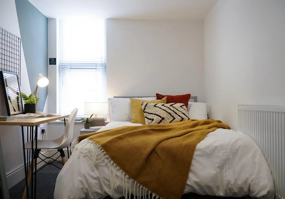 Bed desk lamp chair and plant bedroom at 6 Bedroom House at 3, Baggholme Road in Lincoln Student Accommodation