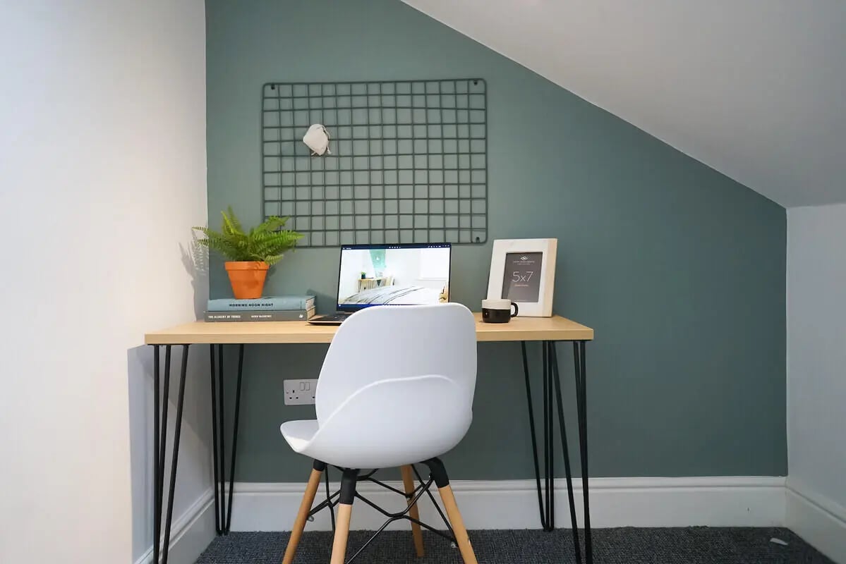 Desk with laptop plant frame mug study area at 6 Bedroom House at 3, Baggholme Road in Lincoln Student Accommodation