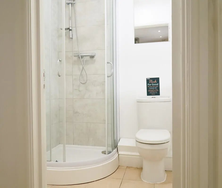 Shower stall and toilet with sign bathroom at 6 Bedroom House at 3, Baggholme Road in Lincoln Student Accommodation