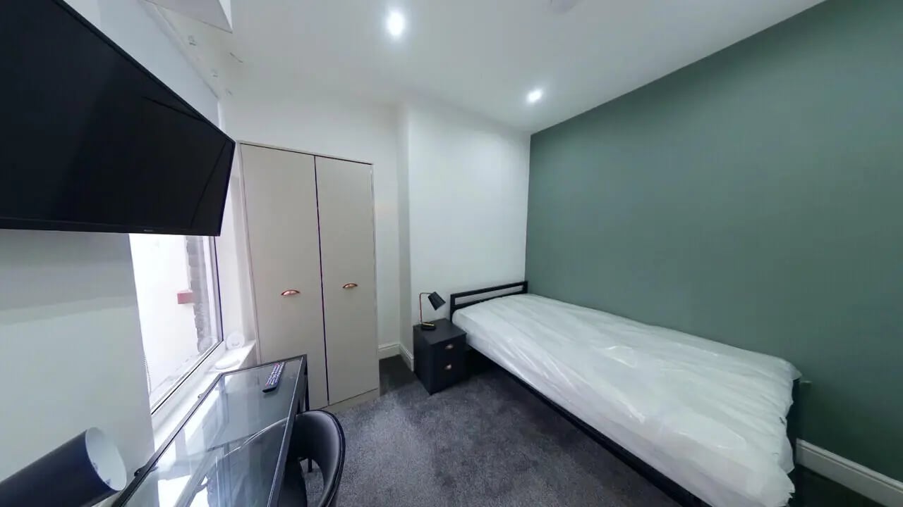 Bed desk wardrobes TV on wall bedroom at 4 Bedroom House at 120, Adelaide Road in Liverpool Student Accommodation
