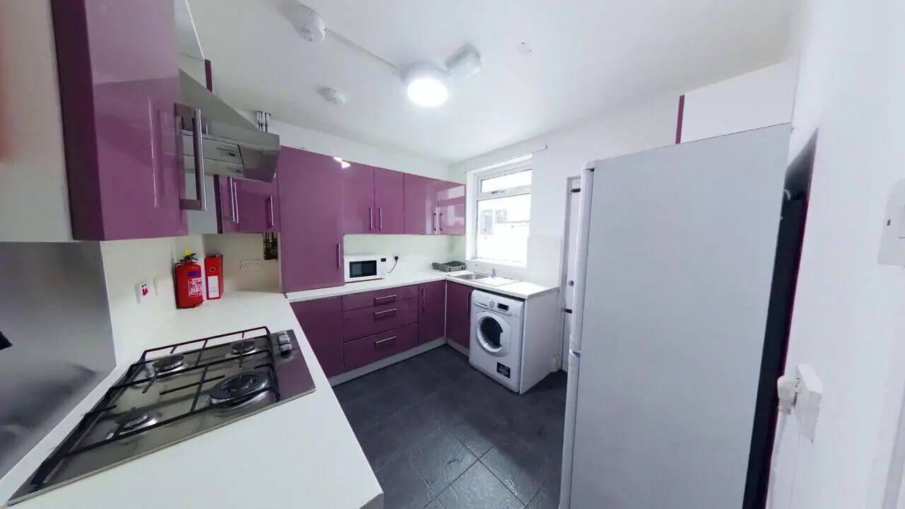Purple cabinets stove microwave washing machine kitchen at 4 Bedroom House at 120, Adelaide Road in Liverpool Student Accommodation