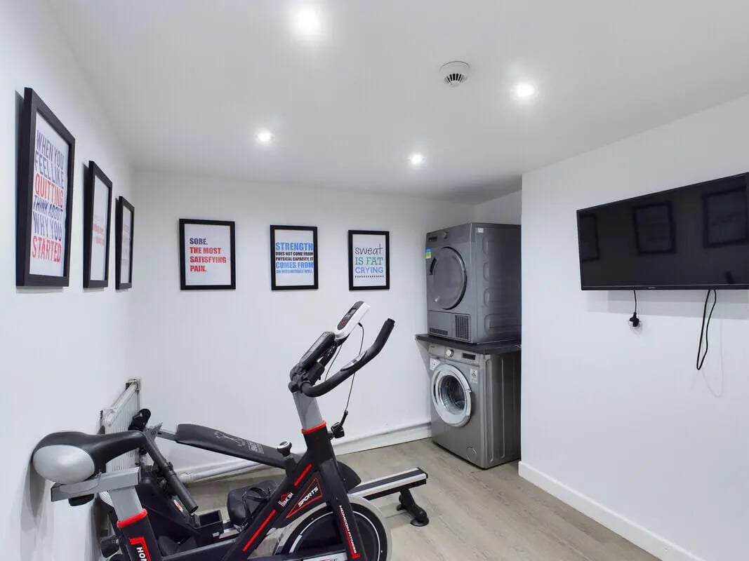 Exercise bike washing machine and dryer living room at 6 Bedroom House at 328, Upper Parliament Street in Liverpool Student Accommodation