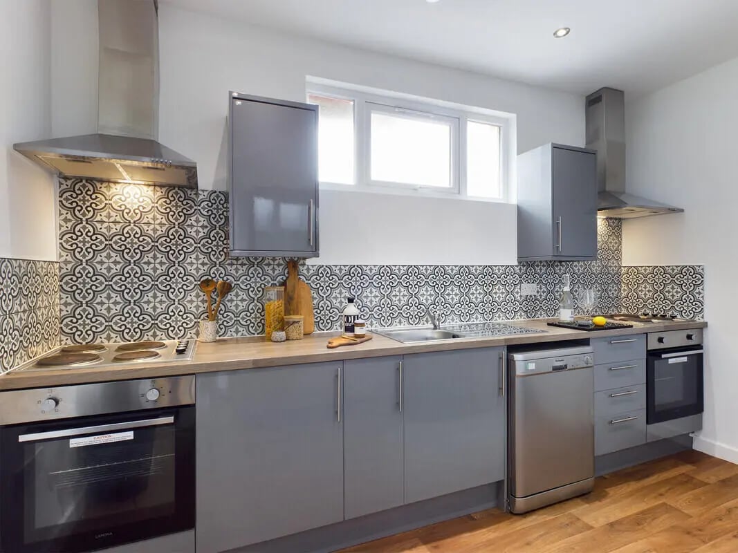 Modern grey cabinets hob oven dishwasher patterned tiles kitchen at 6 Bedroom House at 328, Upper Parliament Street in Liverpool Student Accommodation