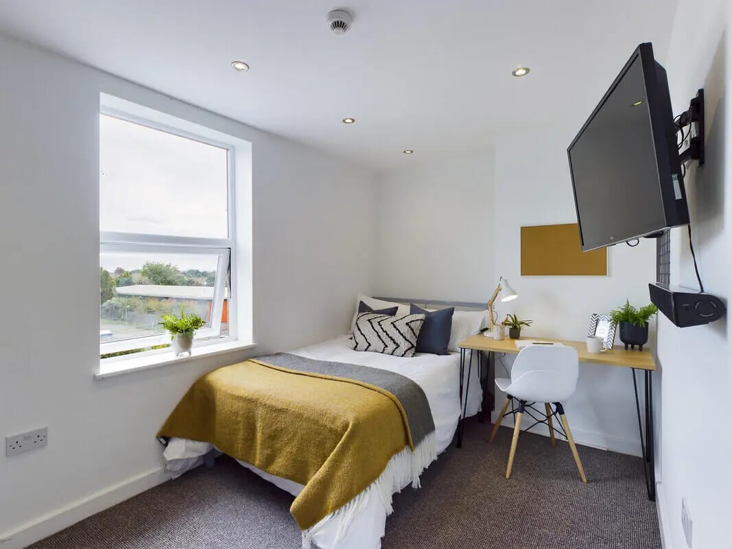 Bed desk plant and TV student bedroom at 6 Bedroom House at 328, Upper Parliament Street in Liverpool Student Accommodation