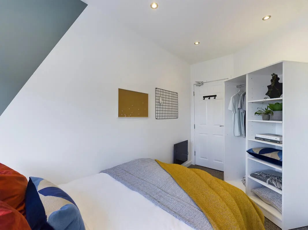 Bed with throws wardrobe and door bedroom at 6 Bedroom House at 328, Upper Parliament Street in Liverpool Student Accommodation