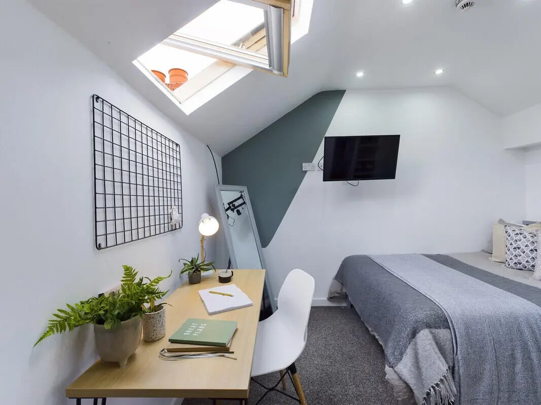 Desk bed television mirror and plants bedroom at 6 Bedroom House at 328, Upper Parliament Street in Liverpool Student Accommodation
