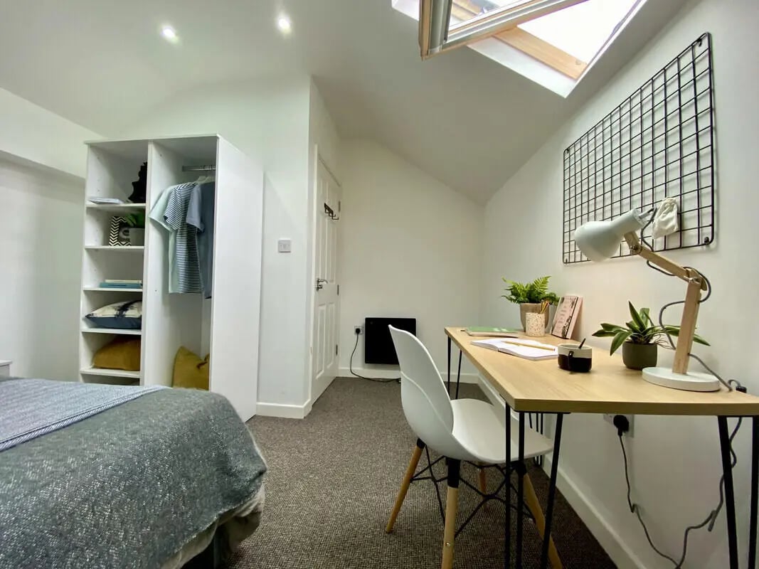 Bed wardrobe desk lamp plants and chair bedroom at 2 Bedroom House at Flat 2, 36, CARLTON AVENUE in Manchester Student Accommodation