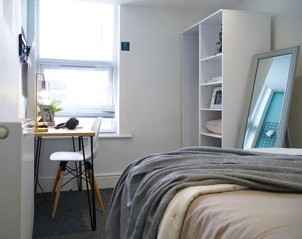 Desk chair bookshelf mirror bed bedroom at 5 Bedroom House at 408, Claremont Road in Manchester Student Accommodation