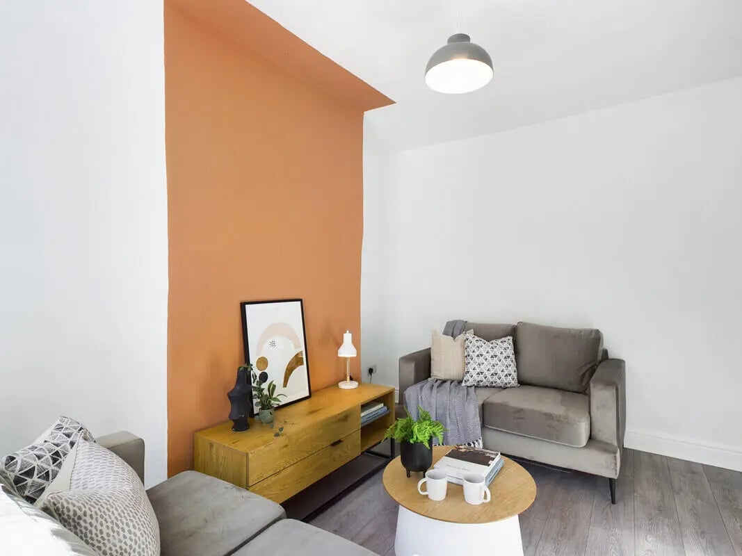 Sofa artwork console table and coffee table living room at 6 Bedroom House at 31, Deramore Street in Manchester Student Accommodation
