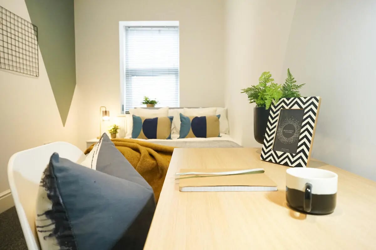 Bed desk lamp photo frame plants bedroom at 6 Bedroom House at 31, Deramore Street in Manchester Student Accommodation