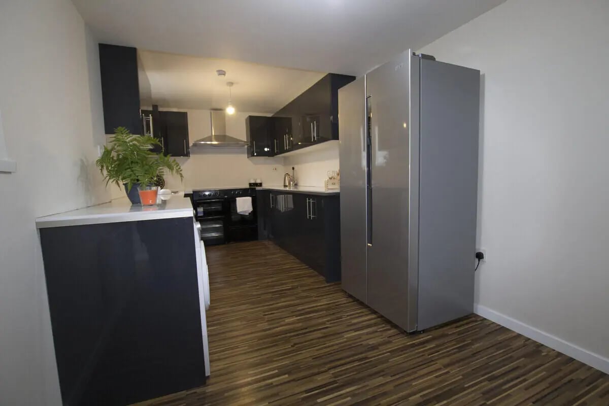Modern kitchen with large fridge and appliances Kitchen at 6 Bedroom House at 31, Deramore Street in Manchester Student Accommodation