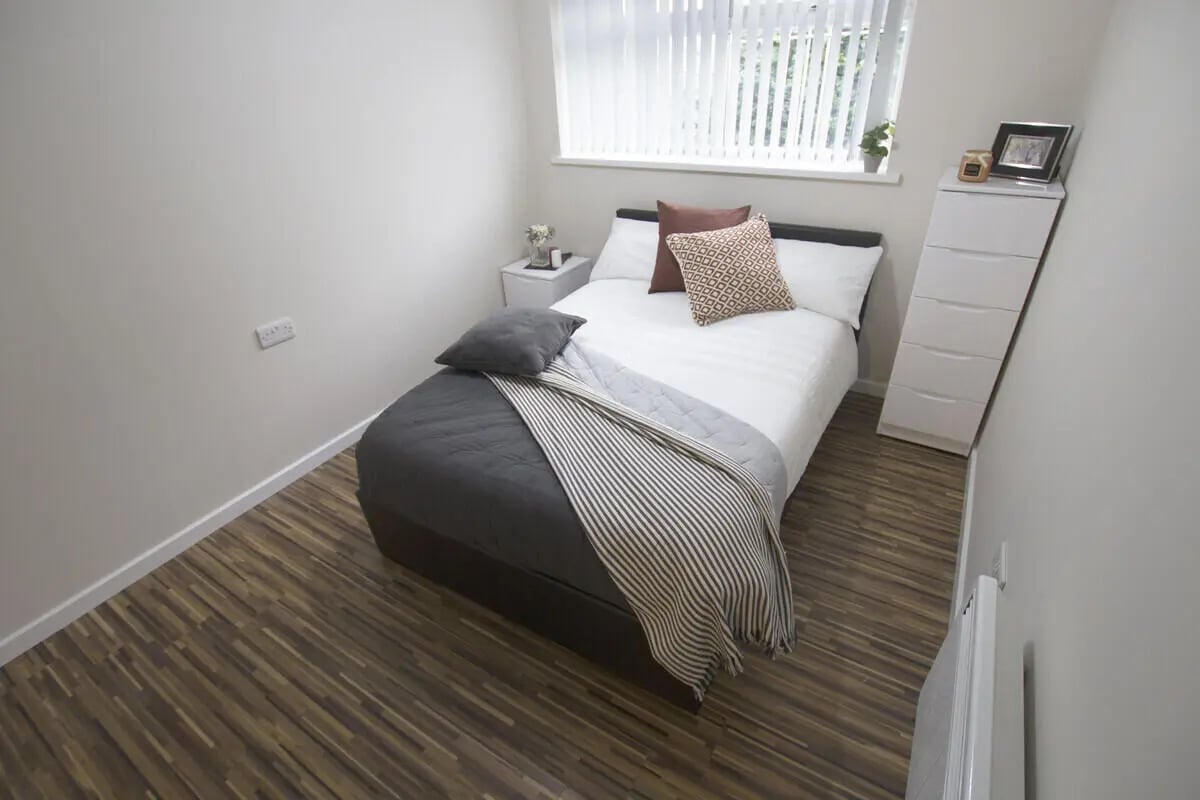 Bed dresser and bedside table bedroom at 6 Bedroom House at 31, Deramore Street in Manchester Student Accommodation