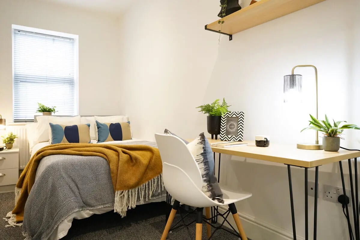 Bed desk pillows plants lamp bedroom at 5 Bedroom House at 14, Driffield Street in Manchester Student Accommodation