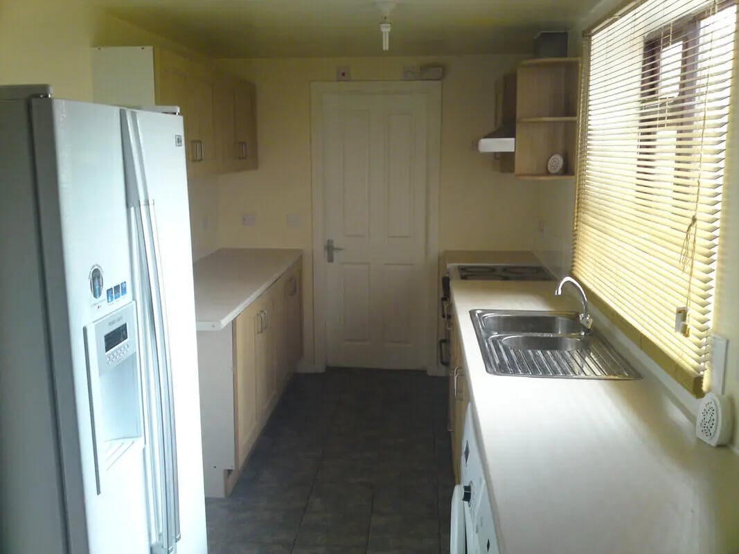 Refrigerator counters cabinets sink stove kitchen at 5 Bedroom House at 14, Driffield Street in Manchester Student Accommodation