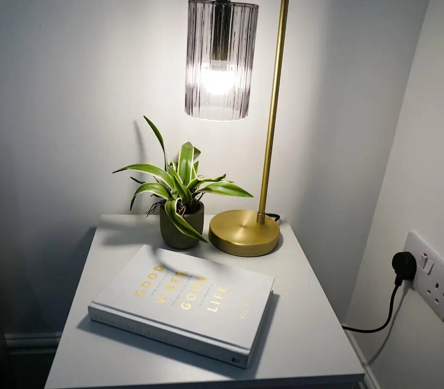 Book plant lamp and outlet bedside table image at 6 Bedroom House at 49, Ruskin Avenue in Manchester Student Accommodation