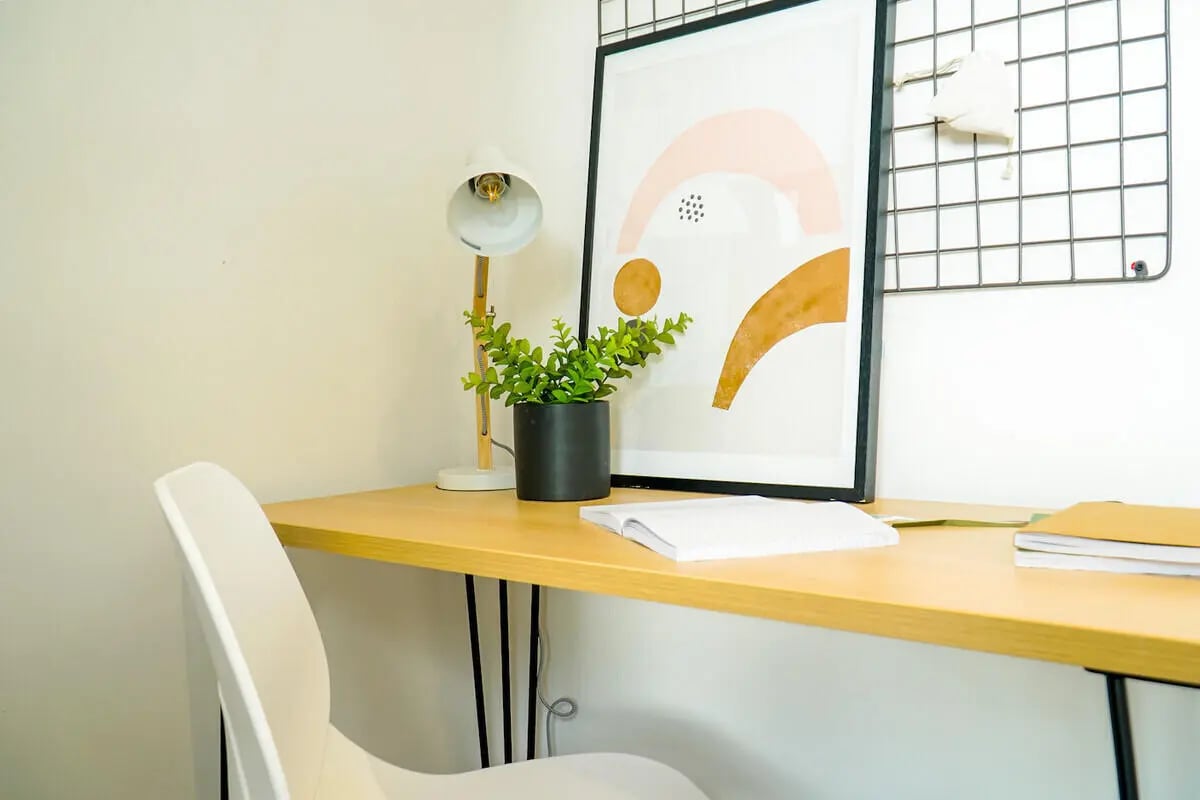 Desk lamp plant art and chair study area at 6 Bedroom House at 49, Ruskin Avenue in Manchester Student Accommodation