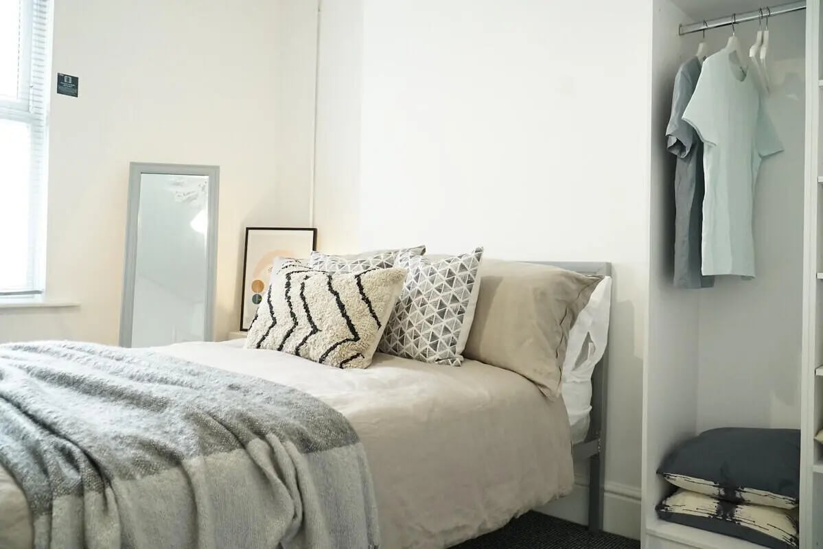 Bed pillows artwork mirror closet bedroom at 6 Bedroom House at 49, Ruskin Avenue in Manchester Student Accommodation