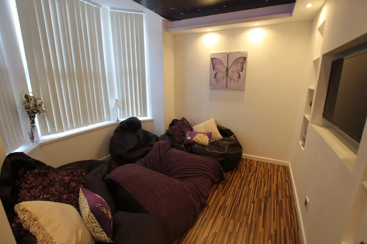Beanbags and pillows by window and TV living room at 6 Bedroom House at 49, Ruskin Avenue in Manchester Student Accommodation