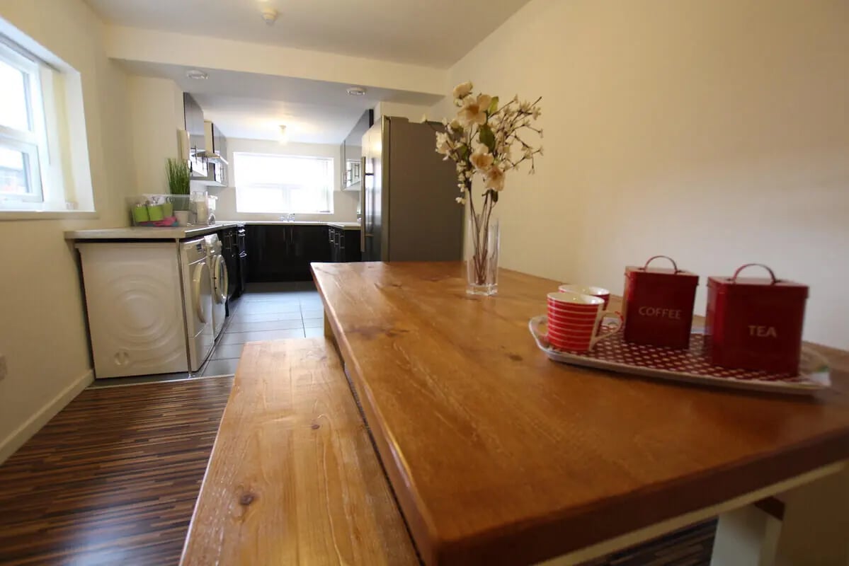 Wooden table with cups and tea coffee tins kitchen at 6 Bedroom House at 49, Ruskin Avenue in Manchester Student Accommodation