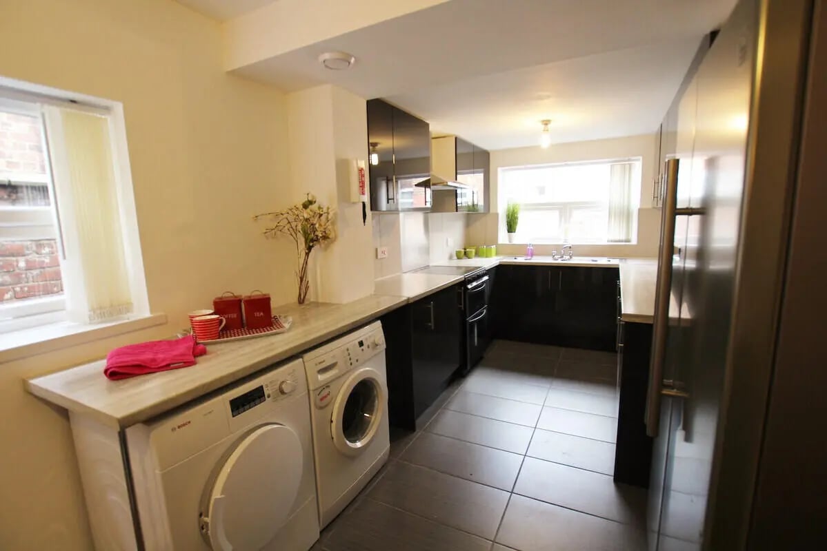 Washing machines and kitchen cabinets kitchen at 6 Bedroom House at 49, Ruskin Avenue in Manchester Student Accommodation