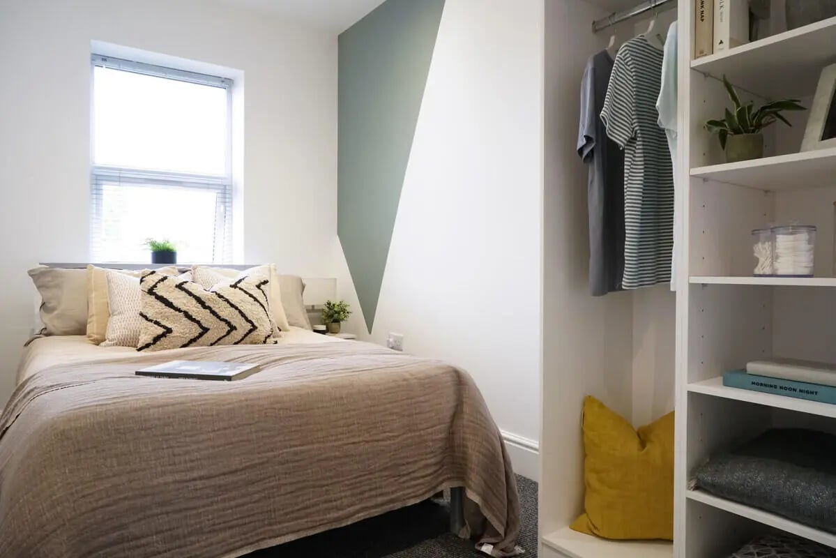 Bed with pillows window closet and shelves bedroom at 4 Bedroom House at 24, Studios at, West Parade in Lincoln Student Accommodation