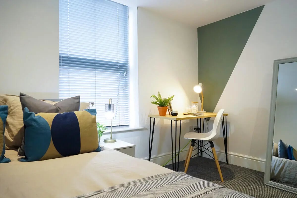 Bed desk chair plant mirror bedroom at 4 Bedroom House at 24, Studios at, West Parade in Lincoln Student Accommodation