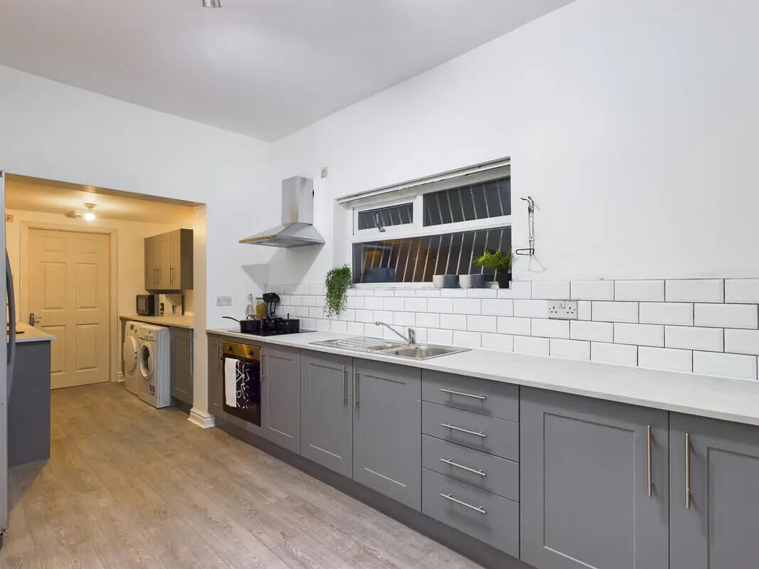 Grey cabinets sink oven washing machine kitchen at 6 Bedroom House at 10, Richmond Road in Lincoln Student Accommodation