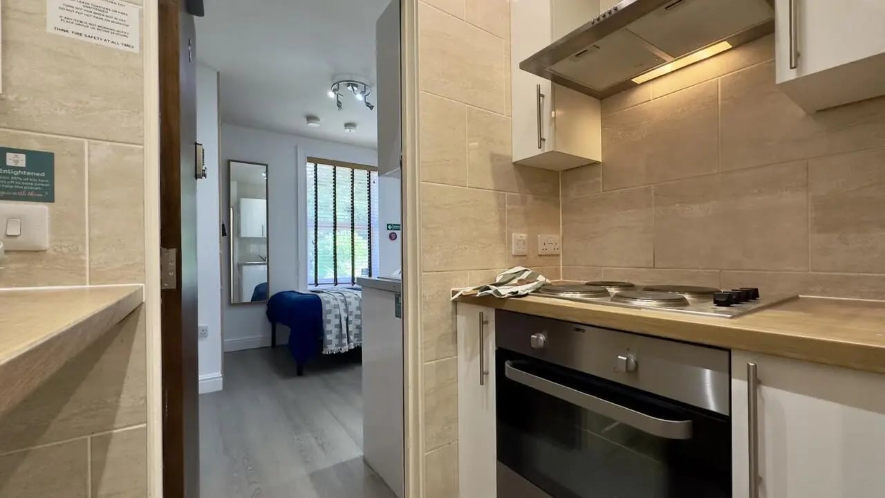 Kitchen with oven stove and bedroom beyond at 6 Bedroom House at 12, Studios at, Richmond Road in Lincoln Student Accommodation