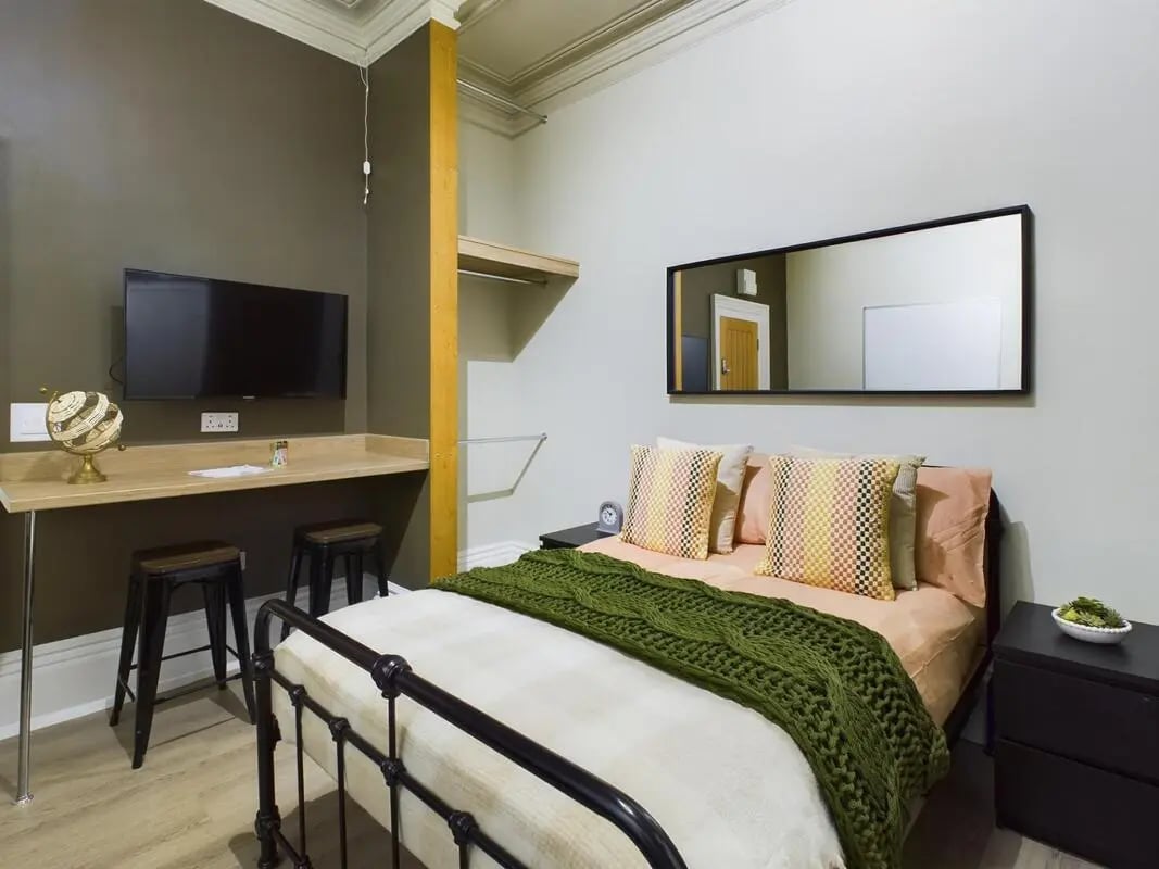 Bed desk stools TV globe and mirror bedroom at 7 Bedroom House at 19, Studios at, The Avenue in Lincoln Student Accommodation