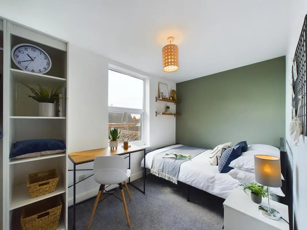 Clock desk chair bed and shelves bedroom at 6 Bedroom House at 73, West Parade in Lincoln Student Accommodation