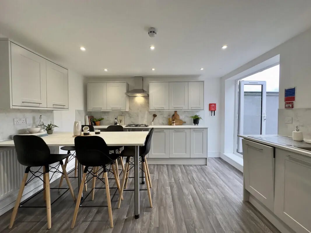 Modern kitchen with dining table and bar stools kitchen at 6 Bedroom House at 43, Monks Road in Lincoln Student Accommodation