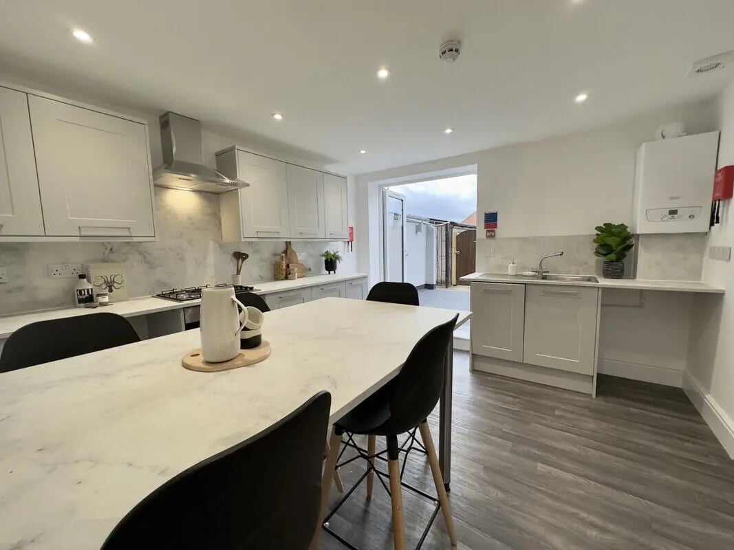 Modern kitchen with dining table and patio doors kitchen at 6 Bedroom House at 43, Monks Road in Lincoln Student Accommodation